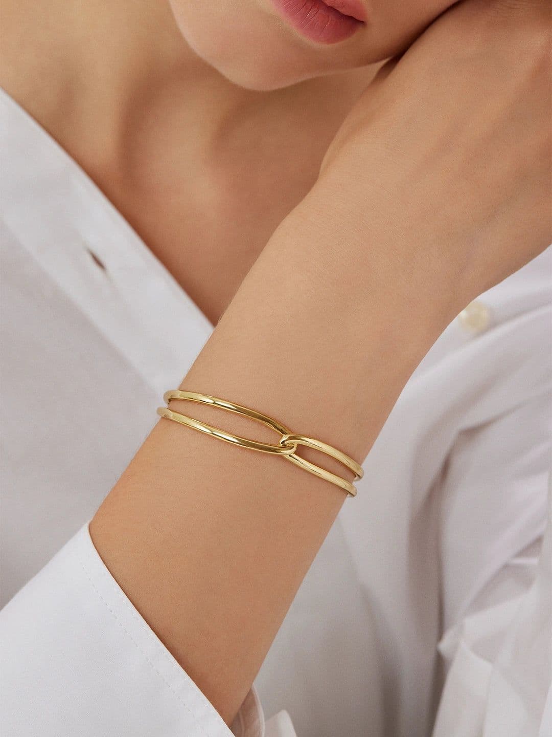 Model wearing delicate gold hoop earrings with natural warm lighting